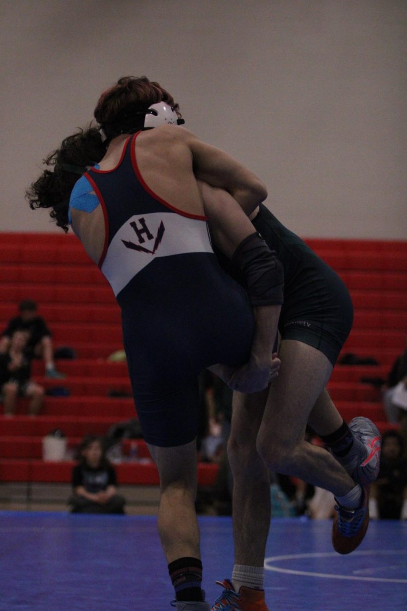 Senior Izaack Cruz Gonzale lifting his opponent