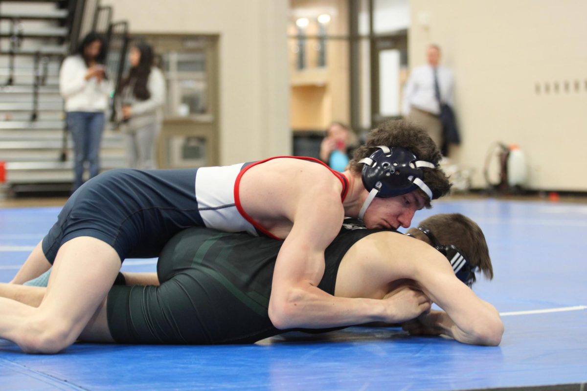 Junior Nick Churney pinning his opponent