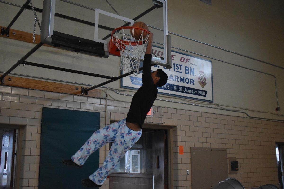 Sophomore Jonathan Ortega dunks a basketball 