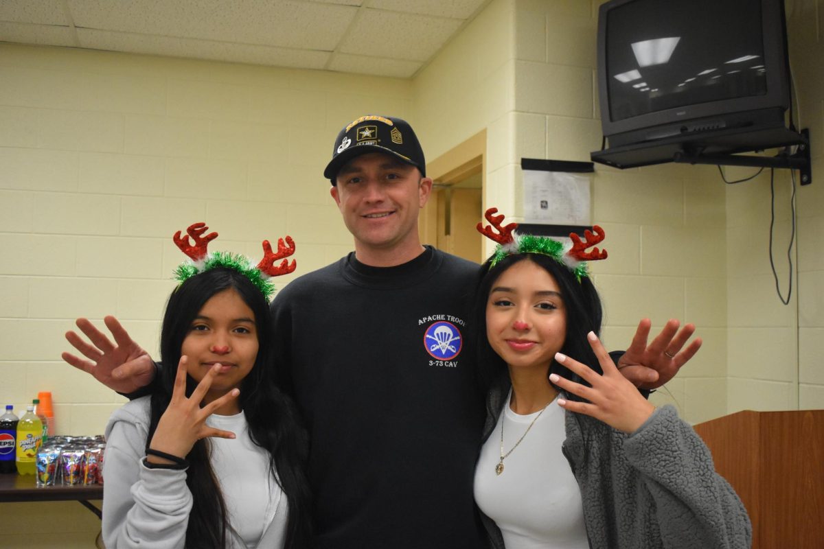 Command Sergeant major and junior Amy Matamoros and junior Abril paiz pose for their group photo of the year.