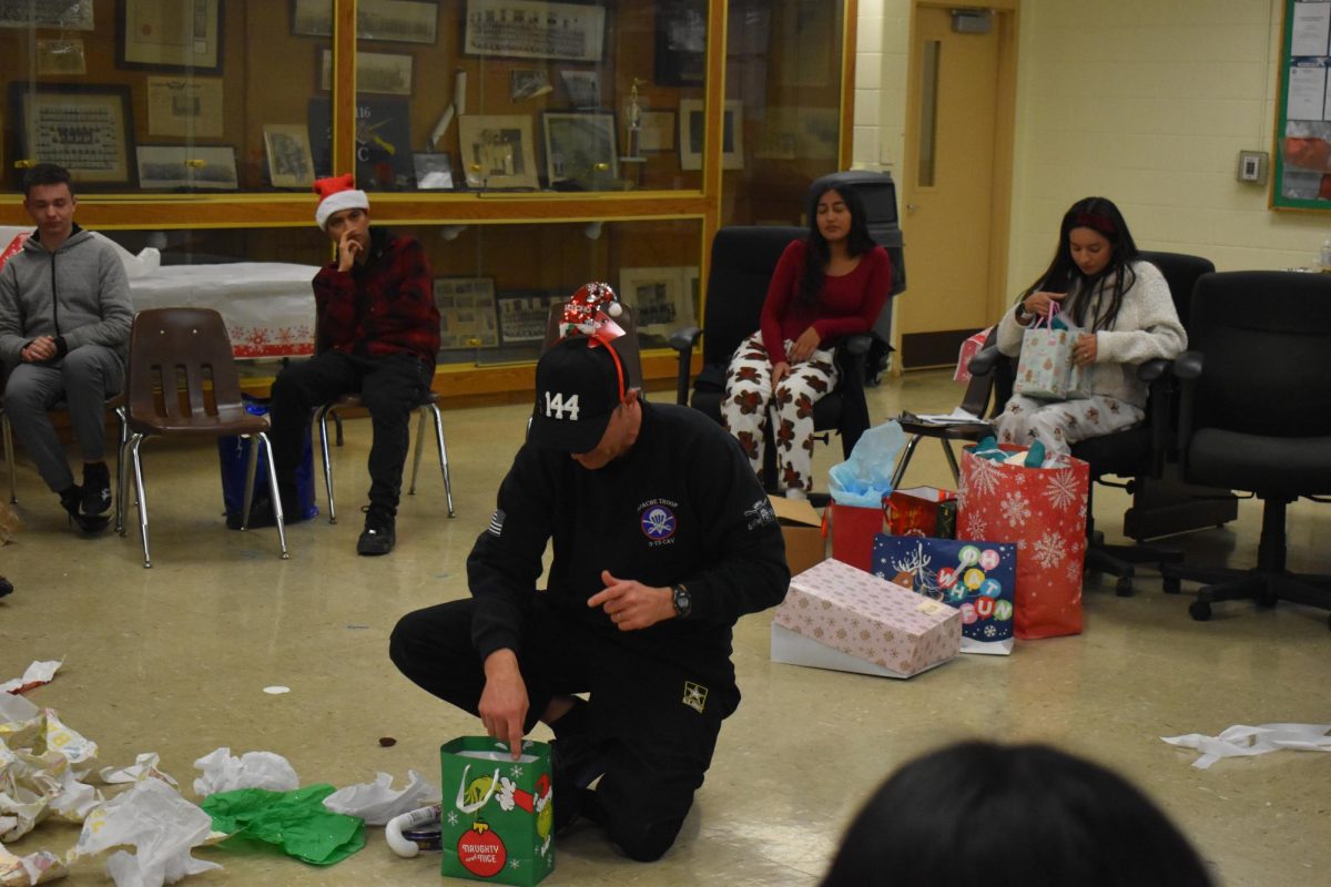 Command Sergeant Major Richard Maccini opening his gifts from his students   