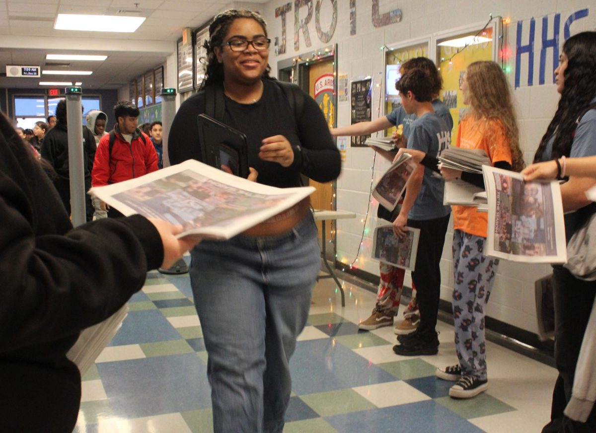 HHS student smiling at the staff members