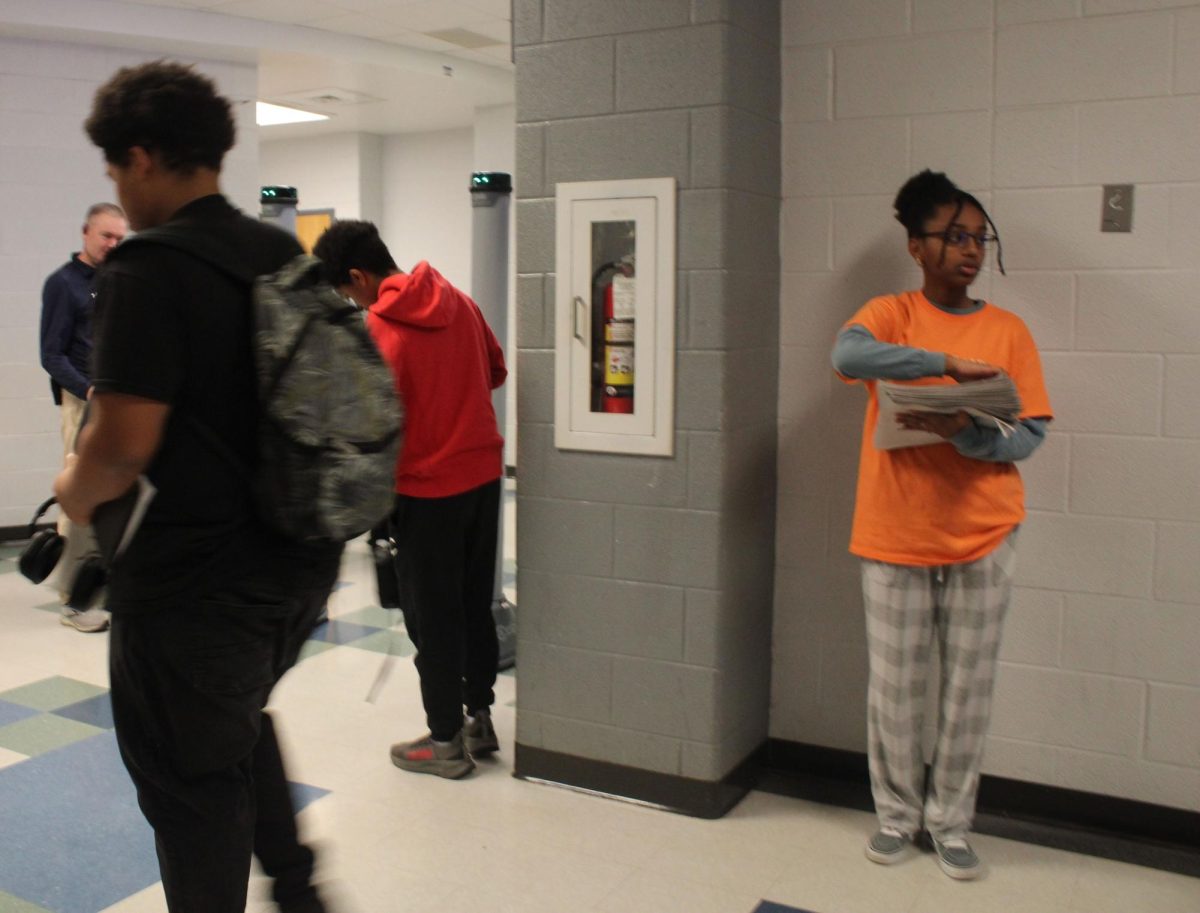 Freshman Hannah Gebru handing out newspapers
