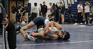 Freshman Mason George on top of his opponent.