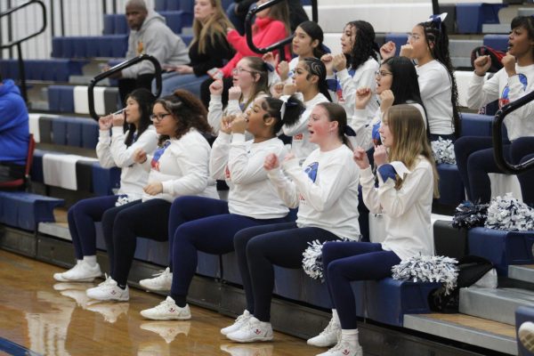 Sideline cheer sings chant for the girls basketball team. 