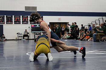 Mason George using his opponent to stand.
