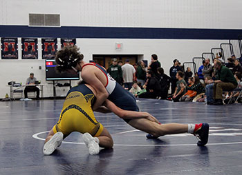 Freshman Mason George fighting to keep his opponent down.