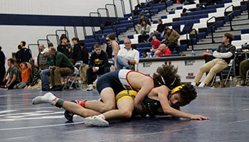 Freshman Mason George on top of his opponent