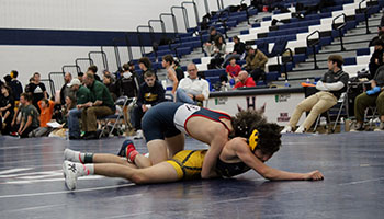 Freshman Mason George maneuvering his way on top of his opponent.