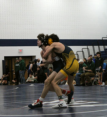 Freshman Mason George standing with his opponent.