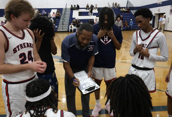 Head Varsity coach Matt Williams talks to his team during a timeout.