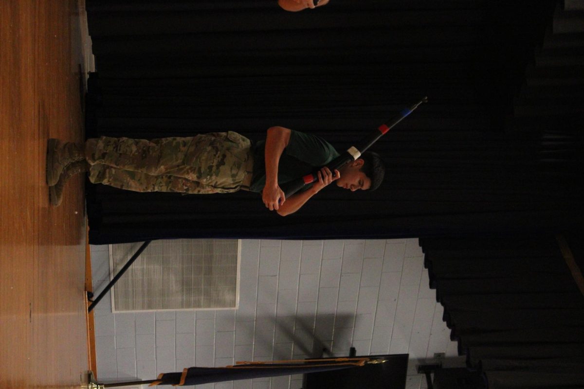Senior Abimar Diaz shows the eighth graders his spin routine