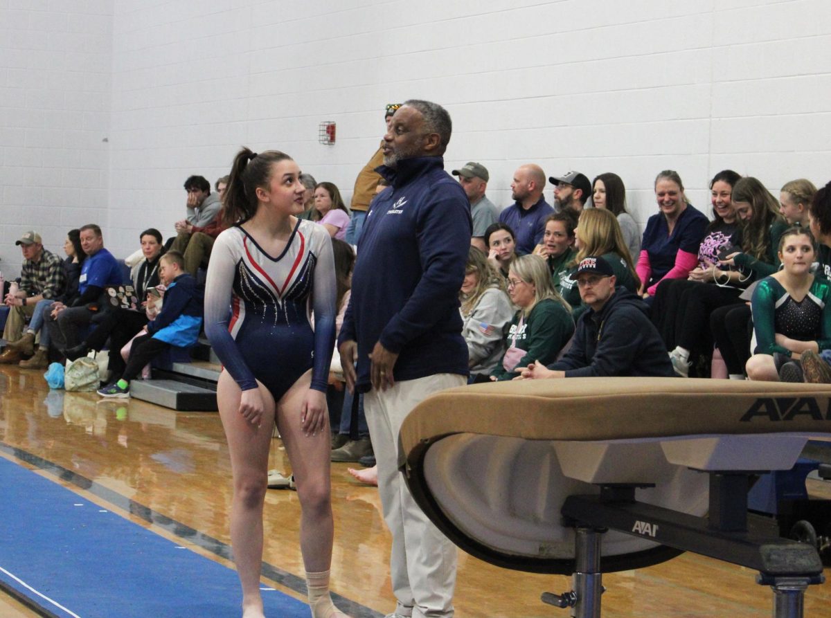 Freshman Rachel Coffman talks with her coach.