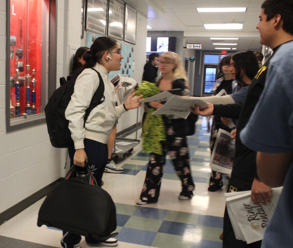 Journalism Staff bombarding HHS student with newspapers