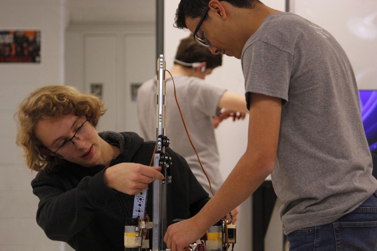 Sophomores Eliel Cortina (right) and Lewis Johnson (left) work together to get their lift system working well.