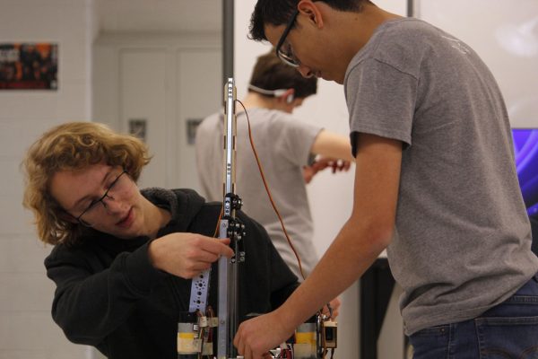 Sophomores Eliel Cortina (right) and Lewis Johnson (left) work together to get their lift system working well.