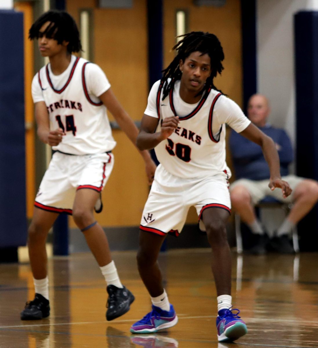 Freshman Mordecai Embaye and Senior Kalaib running down the court.