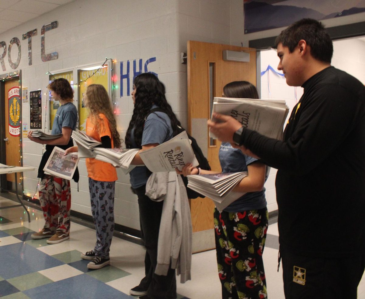 Staff members lined up waiting for HHS students to pass through