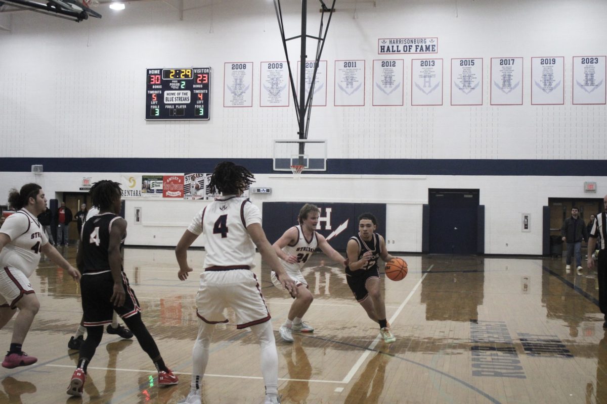 The Harrisonburg High School basketball team attempt to defend as well as try and steal the ball back from Rocktown