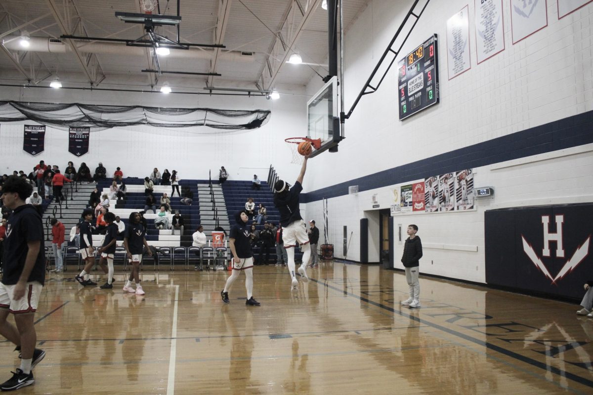 The Basketball team warms up before the game begins