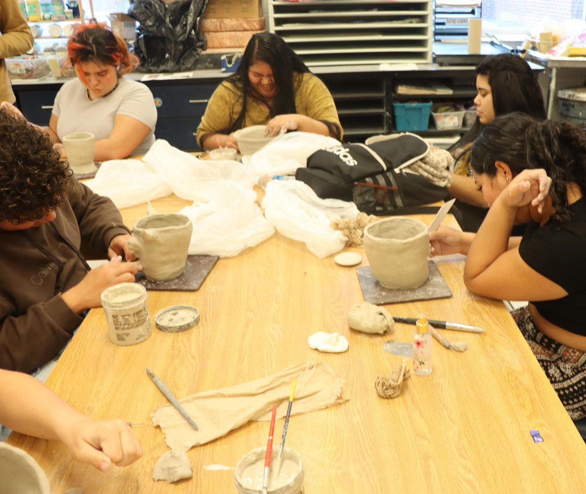 Art students working on pottery.