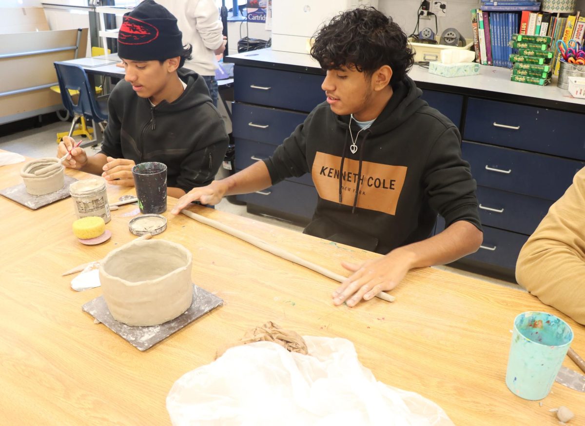 Students working on their pottery art projects.