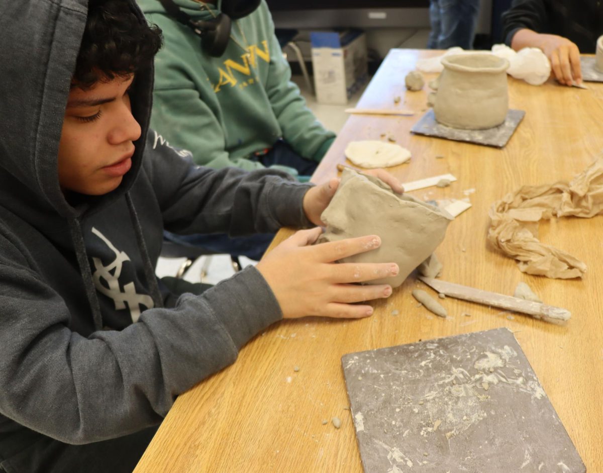 Luis Lizardo working on his pottery.