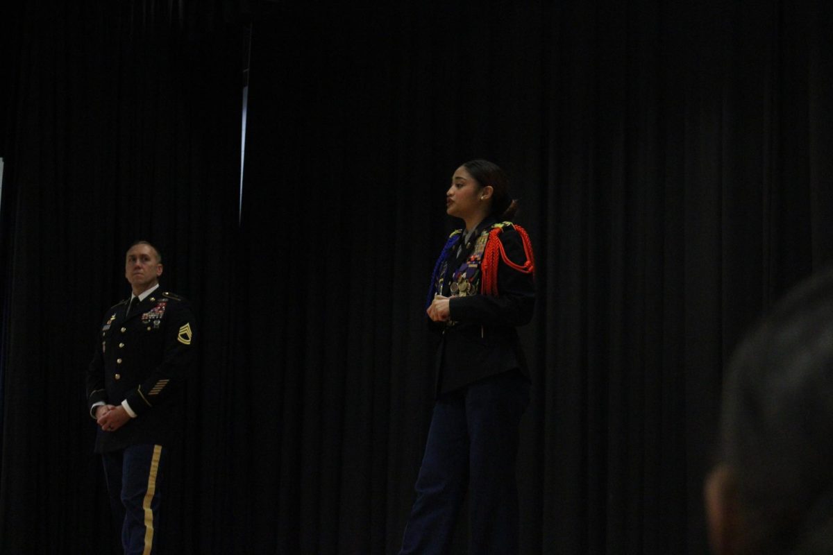 Battalion commander Sophie Lema explaining to the eighth graders what JROTC is about.