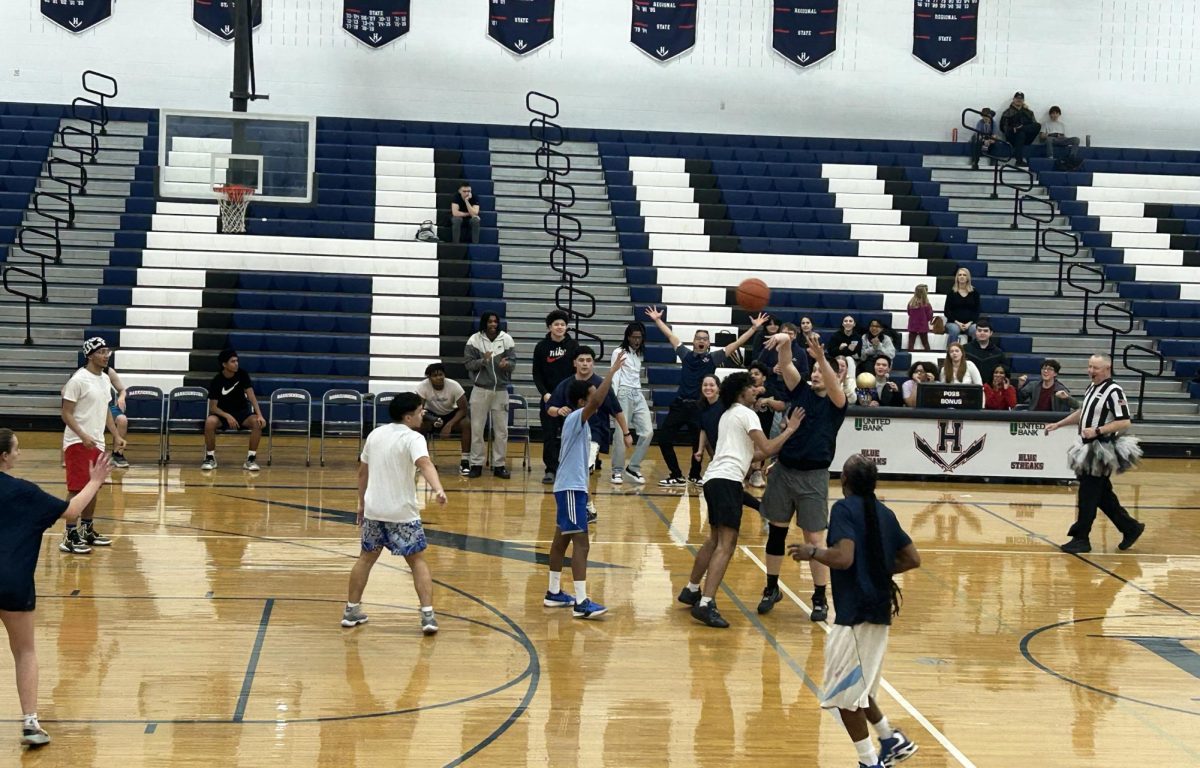 Mr. Lichti passes the ball into the students defense.