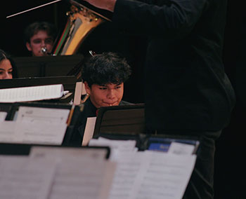 Freshman Juan Antonio Rivera is playing the flute that brings warmth to the winter night.