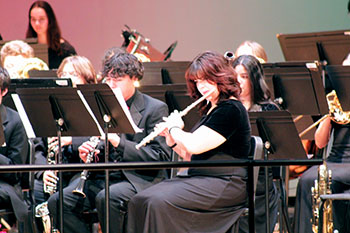 Sophomore Olivia Carickhoff is playing the flute, captivating the audience with every note.