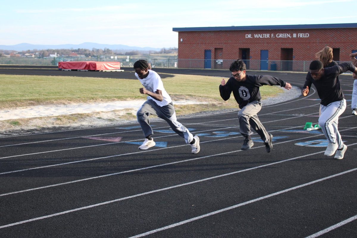 Track athletes practicing their block starts