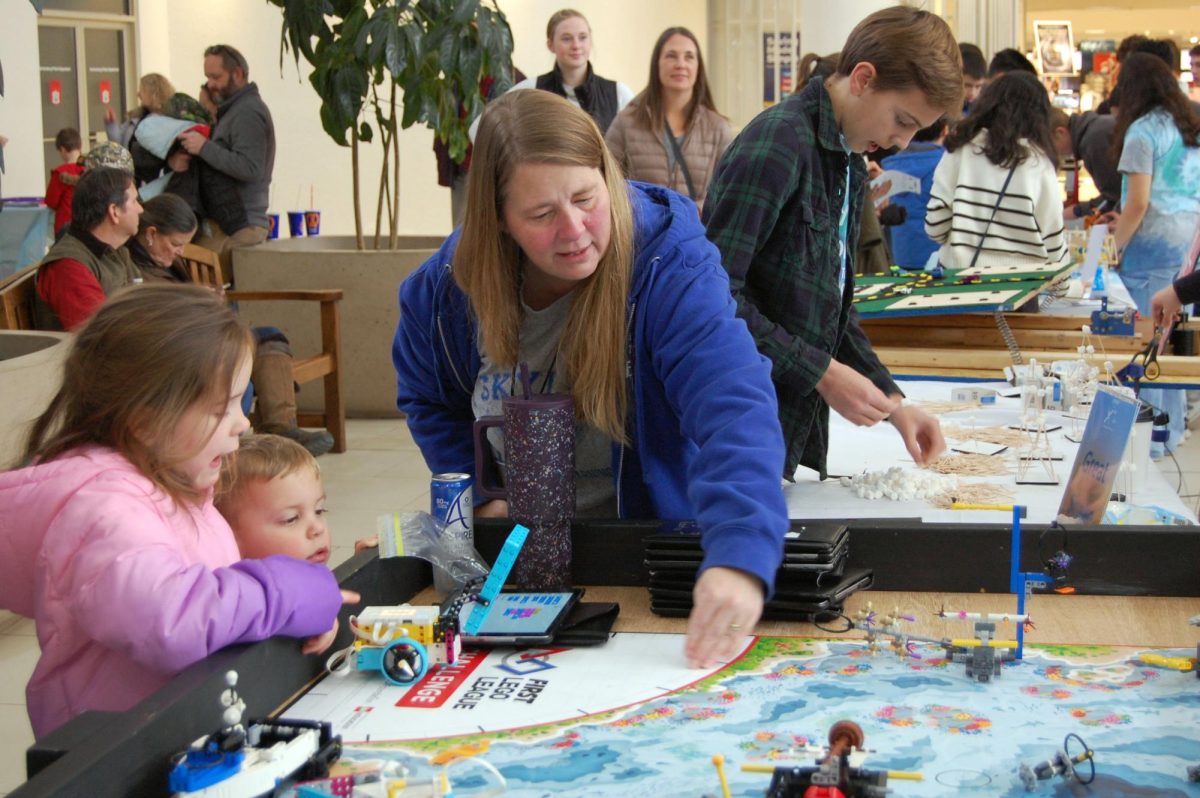 STEM adult helps explain the FLL competition.