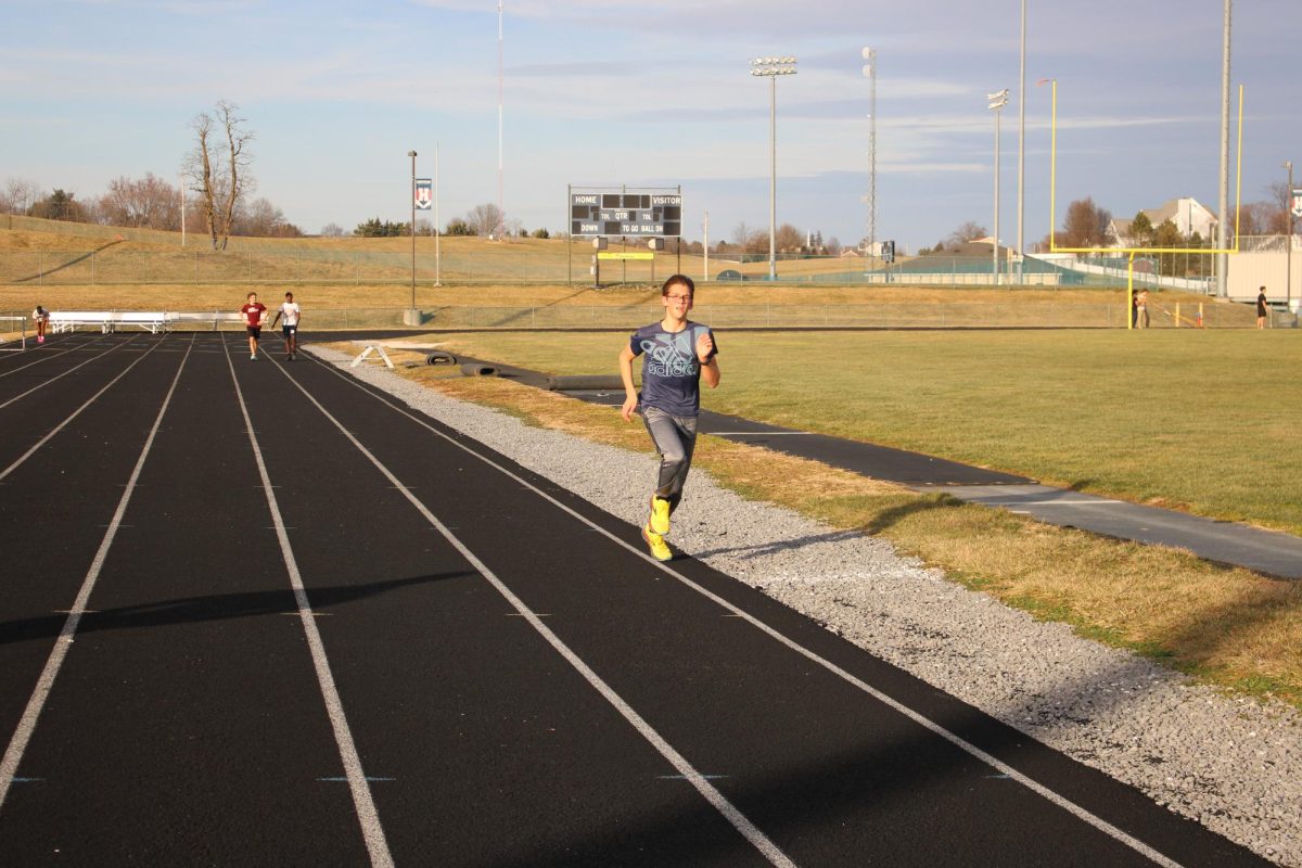 Track athlete running laps at practice