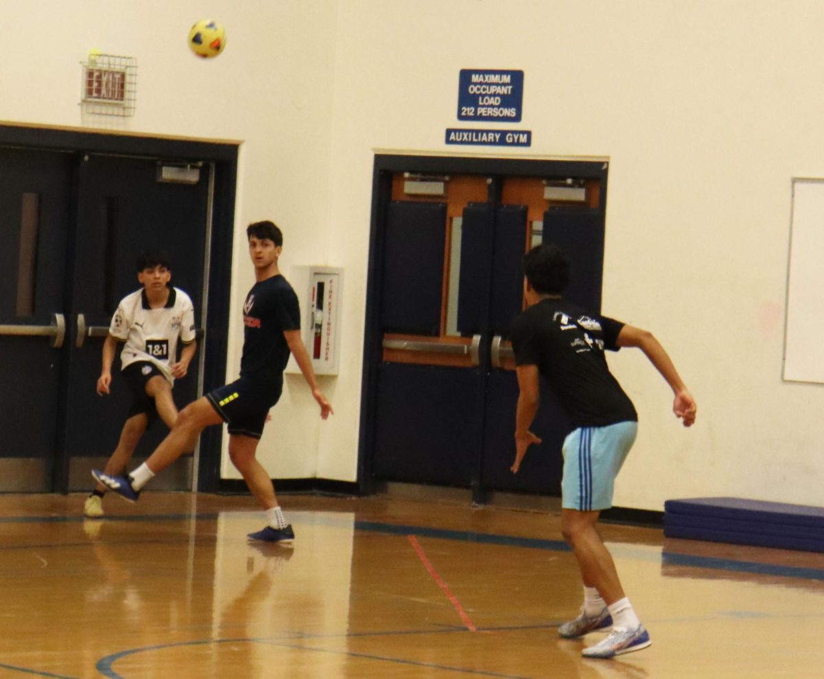 Senior Miguel Osorto tries to pass down the gym.