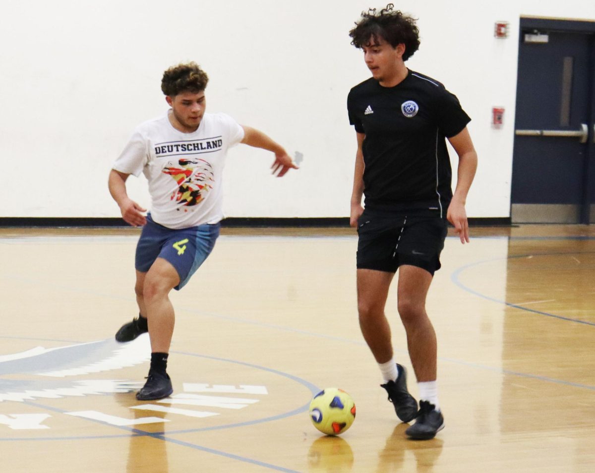 Senior Rayyan Garout tries to pass the ball.