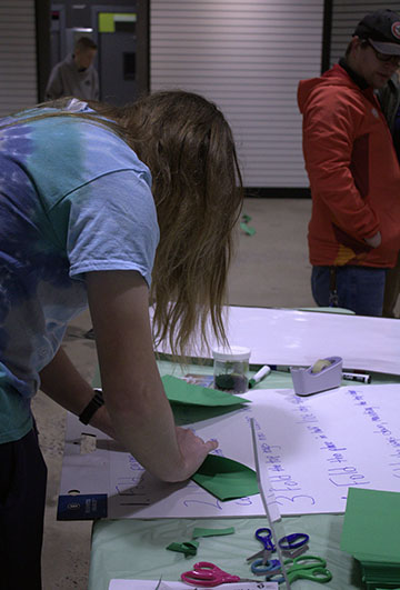 Senior Elliot Rhodes making a paper airplane.