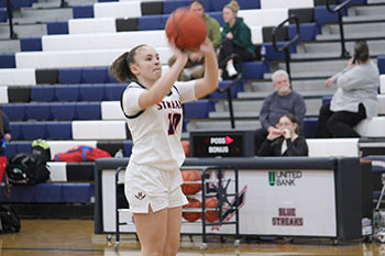 Sophomore Ah-Ghia Jones playing in the last basketball game of the season at HHS.