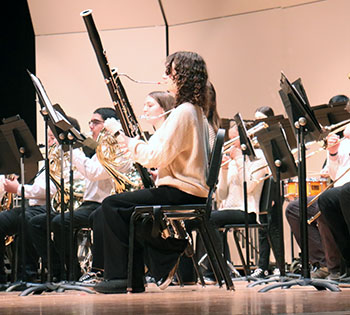 Students in the symphonic band play their clarinets.