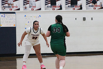 Senior Kayli Alvarado is blocking a player from the opposing team.