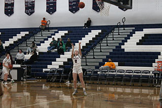 Senior McKenna Dayton is practicing her shoot's for the game.