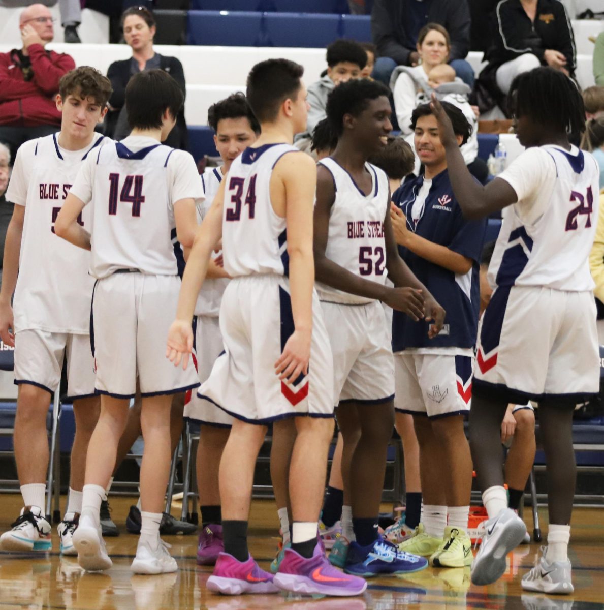 Freshman Yusuf Bakebuga high fiving his teammates 