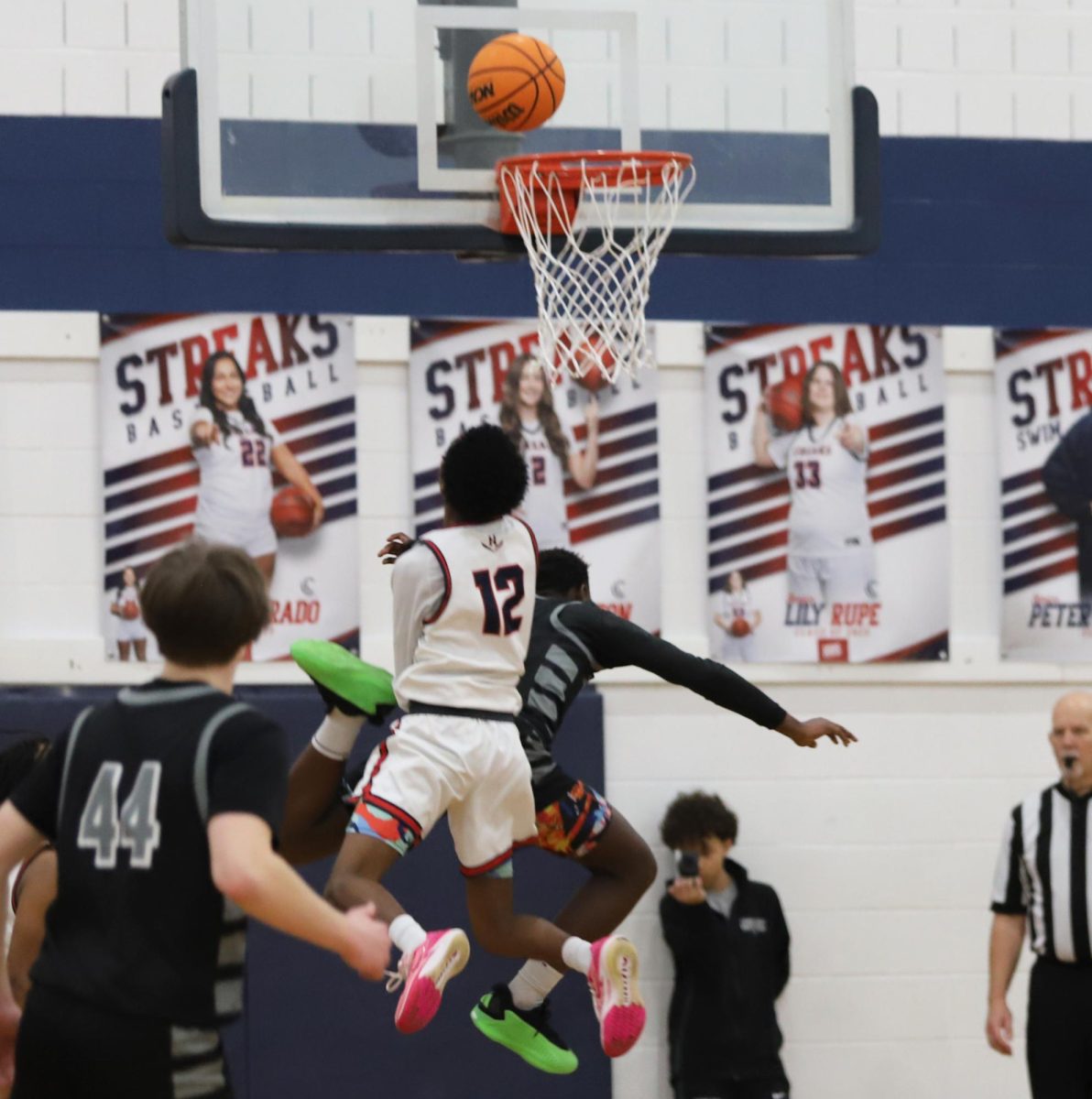 Senior Merhowe Gebrenegus kocking Turner Ashby out of the air to gte the ball.	