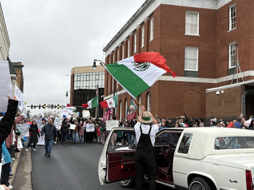 Man waving around mexican flag at Downtown Harrisonburg peaceful protest, which HHS students attended.