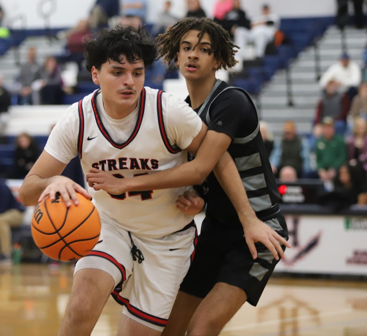 Senior Nick Santiago trying to get away from Turner Ashby to shoot the ball.