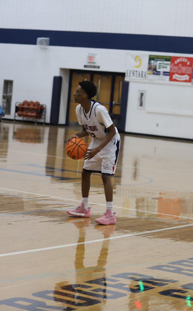 Sophomore Pierre Ngeleka holding the ball