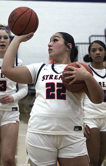 Kayli Alvarado passes a ball to her teammate during practice time.