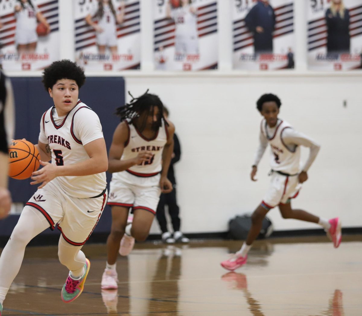 Sophomore Yandel Robles running down the court with the ball.