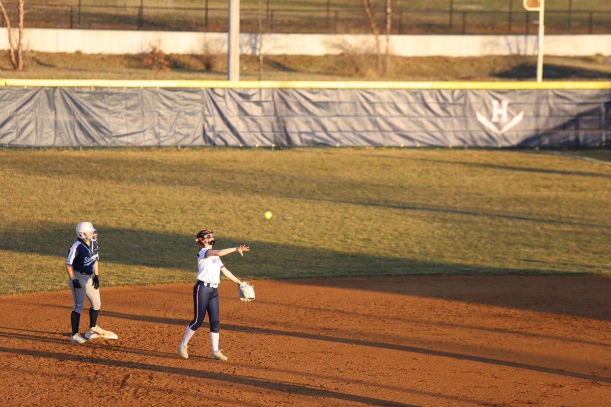 Sophomore Kyleigh Morris tosses the ball back to the pitcher.