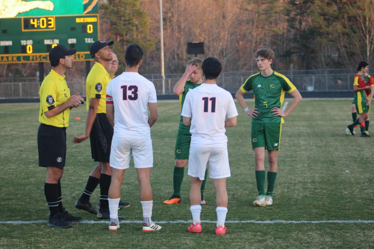 Seniors Miguel Osorto and Izaack Cruz meet with the refs before the game.